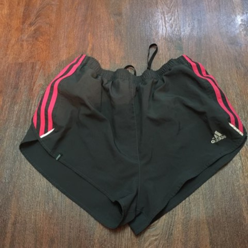 Black Adidas track shorts with pink strips